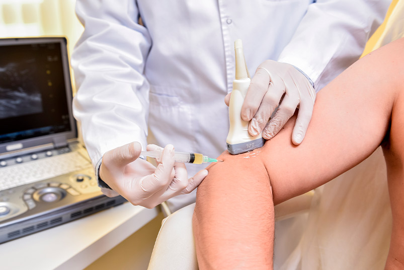 A man getting an injection in his arm, highlighting the effectiveness of combining PRP with shockwave therapy.