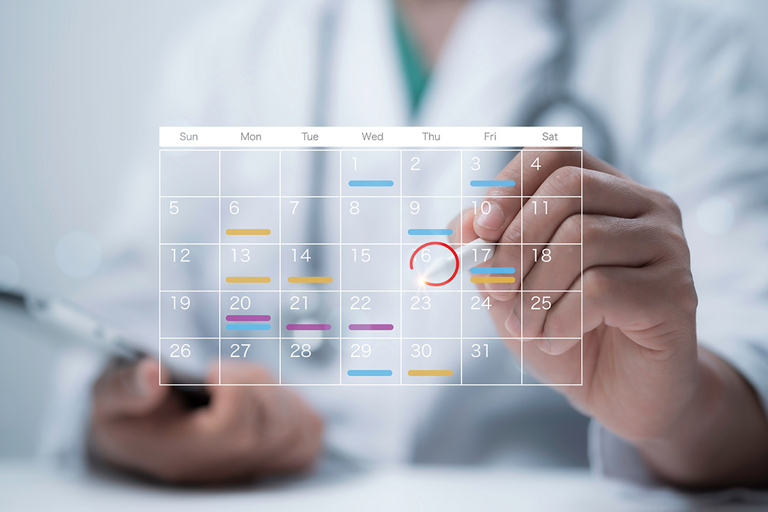 A doctor displays a calendar with a red circle, highlighting key dates for enhancing clinical efficiency during fall sports season.