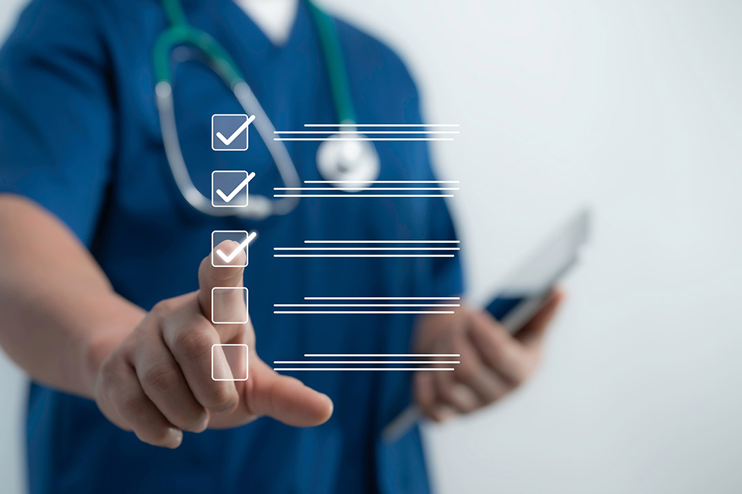 A doctor examines a tablet with a checklist, highlighting patient flow optimization for clinics during the Thanksgiving rush.