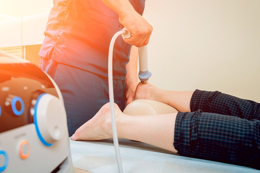 Individual enjoying an electric massage on a bed, emphasizing comfort and wellness during the winter season.