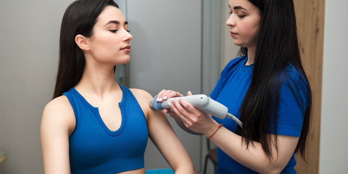 ESWT machine: woman receiving treatment. 