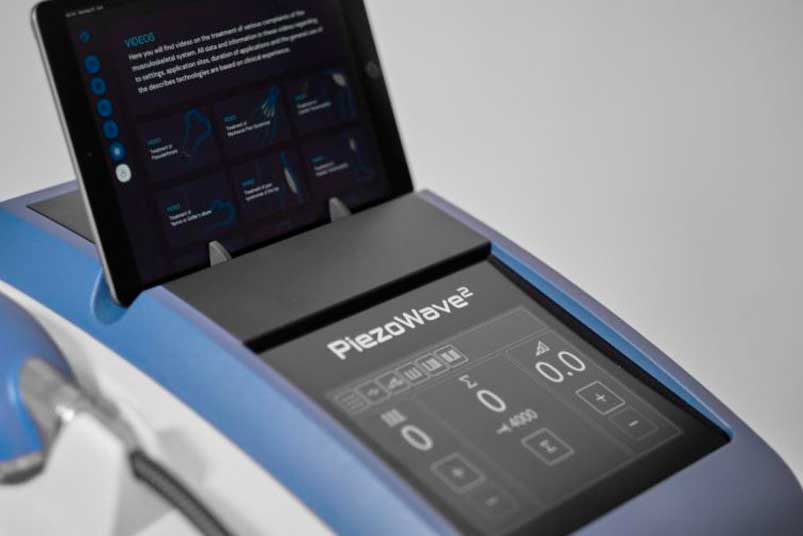 A digital tablet showcasing information relevant to the best shockwave therapy machines for physical therapy clinics.